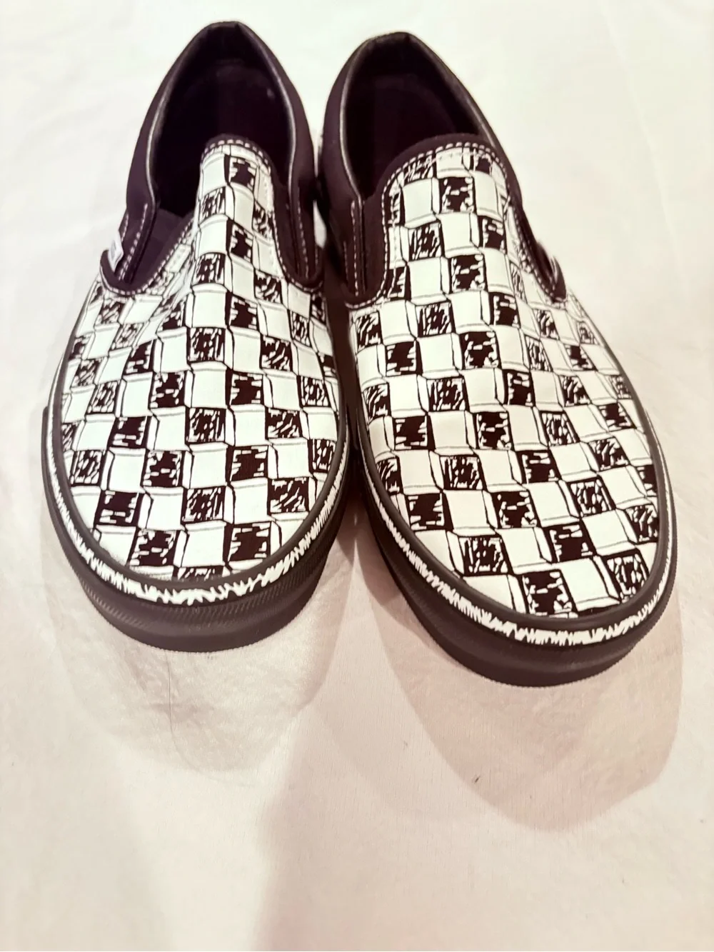 Vans Black and White Checkerboard Slip-On Sneakers